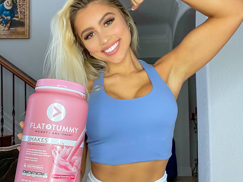 Andrea holding a Flat Tummy Strawberry Shake
