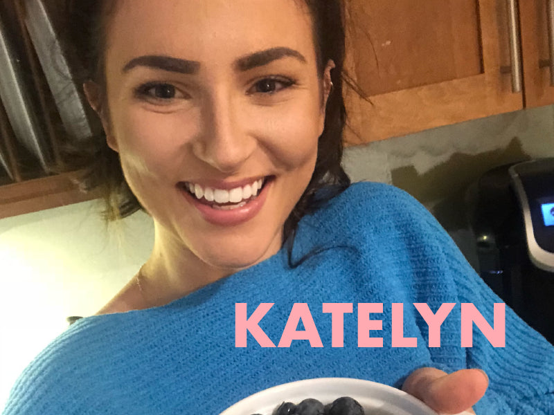 Smiling person holding a bowl of blueberries in a kitchen. The text "KATELYN" is displayed in large pink letters.