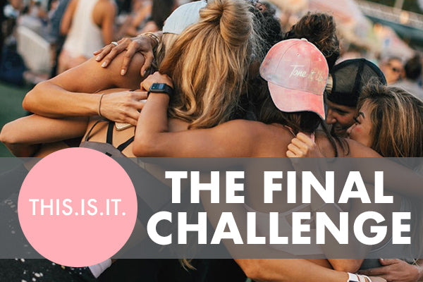 A group of people embraces in a tight circle outdoors. They wear casual summer clothing, and one person has a cap. Text over the image reads: "THIS.IS.IT. THE FINAL CHALLENGE.
