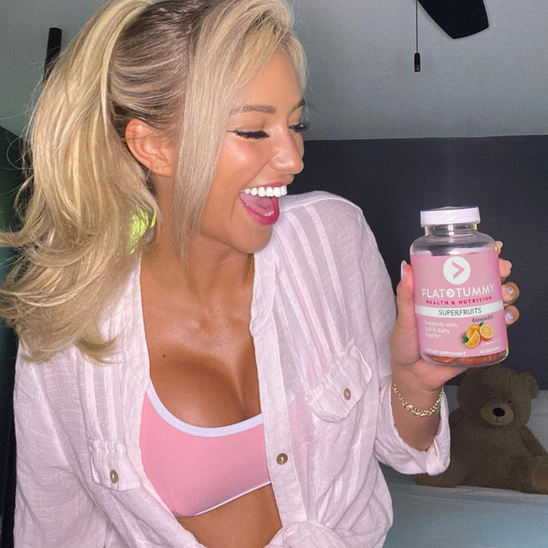 joyful woman holding superfruits gummies