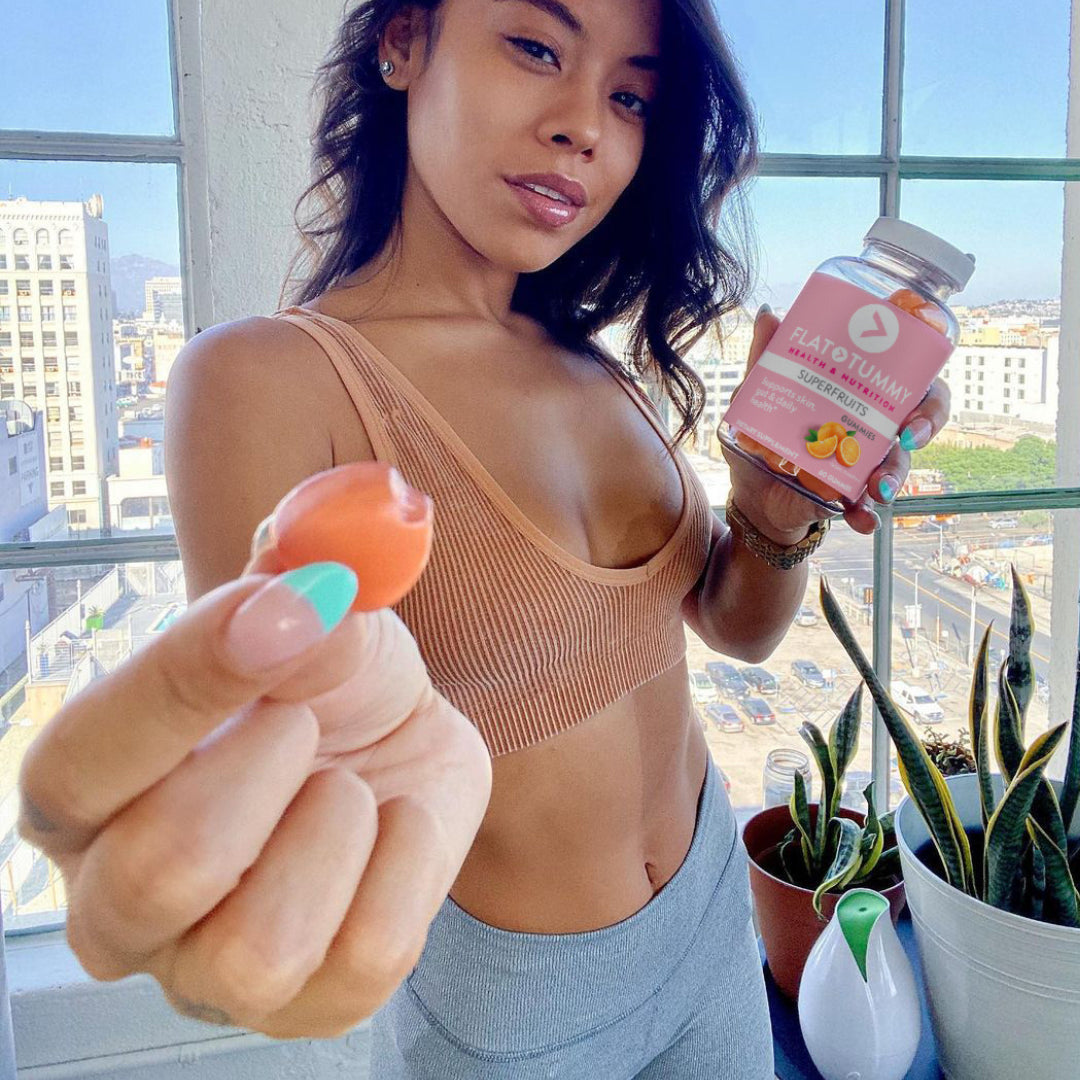 Closeup of woman holding superfruits gummy