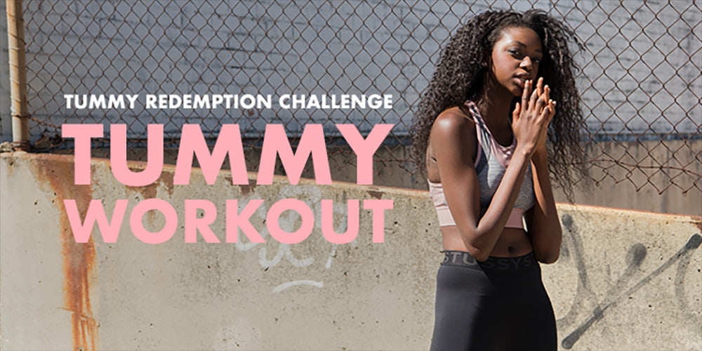 A person with long, curly hair stands outdoors in athletic wear against a chain-link fence. "Tummy Redemption Challenge: Tummy Workout" is written in bold pink and white letters beside them.