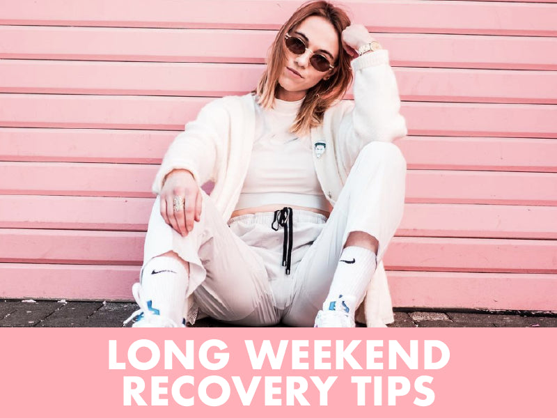 girl sitting down pink wall