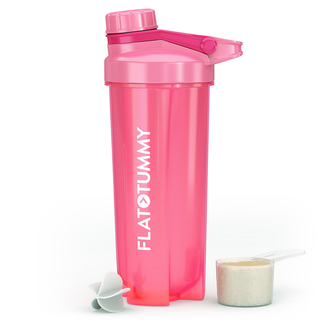 The pink "Flat Tummy Co" Shaker Bottle is upright for protein shakes, with a plastic scoop of powder and a white mixing ball beside it. It has a screw-on cap and flip-top lid for easy access.