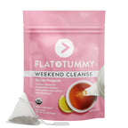 A pink resealable bag labeled "Flat Tummy Cleanse" by Flat Tummy Co contains a 30-day program of organic detox tea. The front features a cup of tea with a lemon slice and a pyramid-shaped tea bag beside it. USDA Organic certified to cleanse the colon effectively for that flat tummy result.